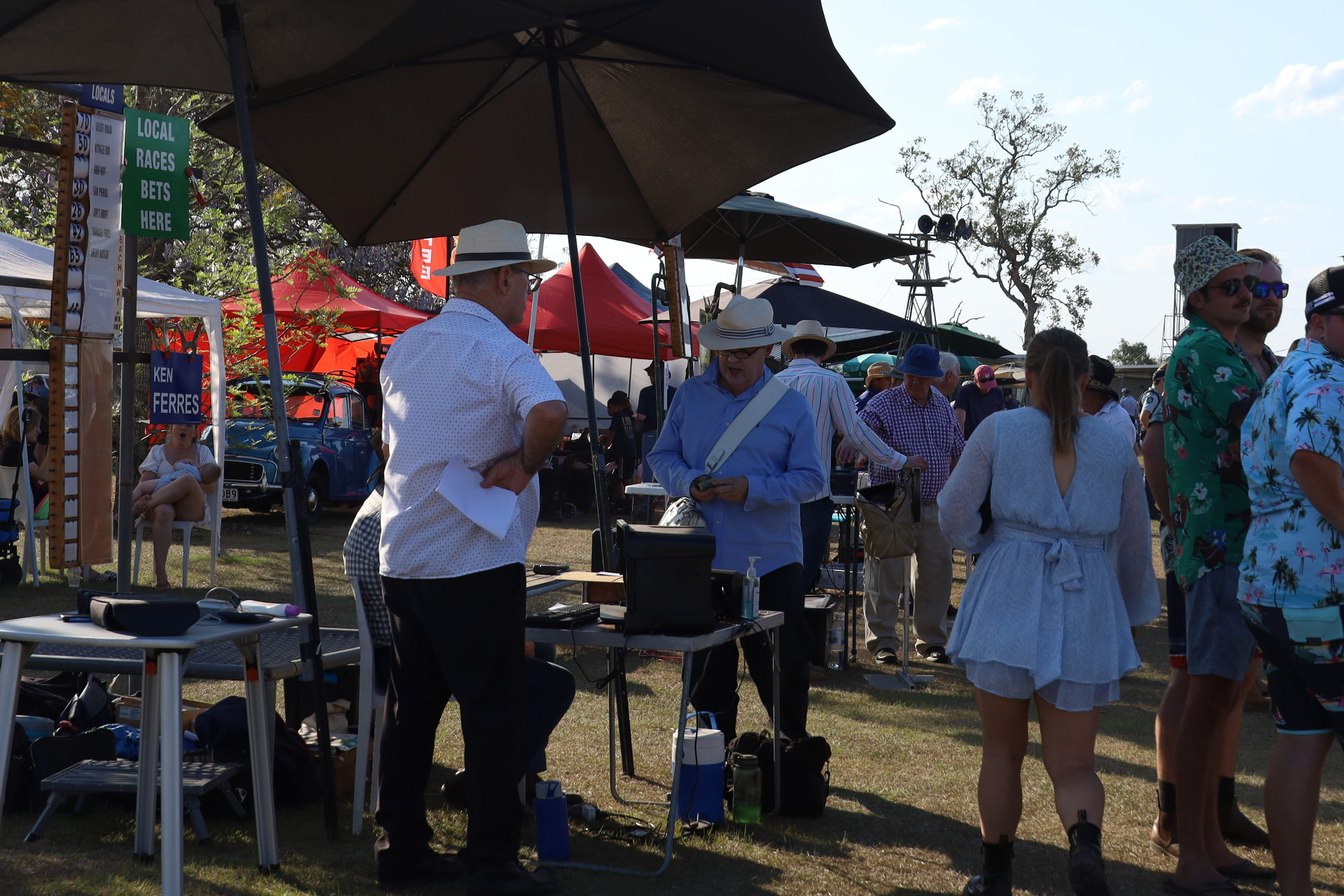 Bookmakers taking bets under umbrellas