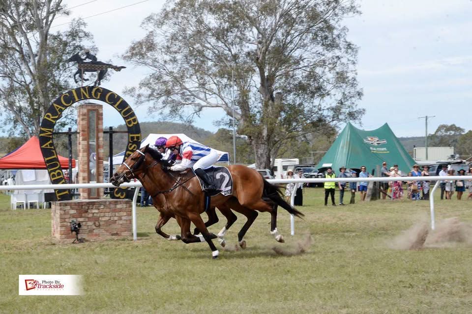 Two horses fighting out the finish past the Tabulam Racing Club arch